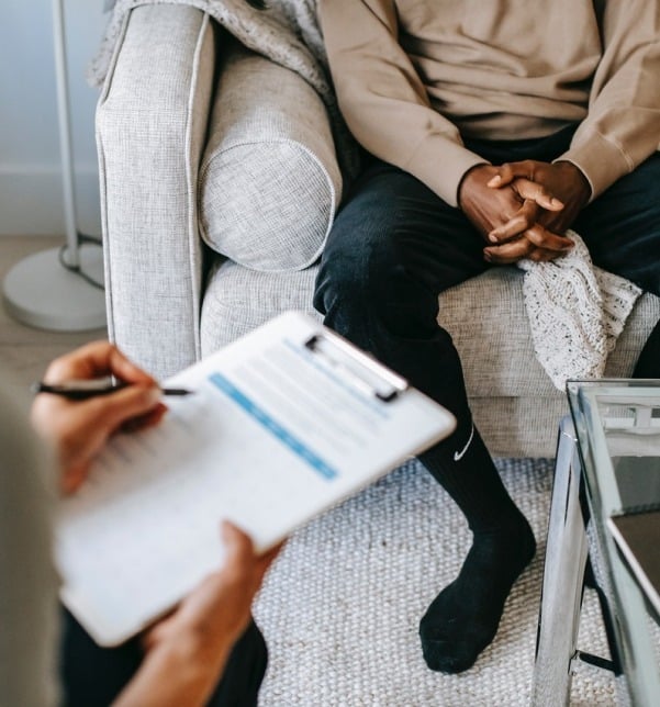 Calm clinical setting where a patient discusses OCD symptoms with a psychiatric clinician.